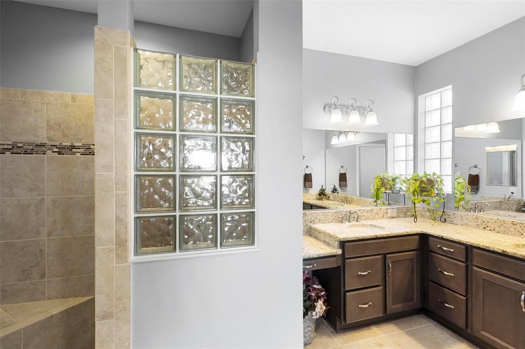 Primary Bathroom with Snail Shower, double vanities, granite counters