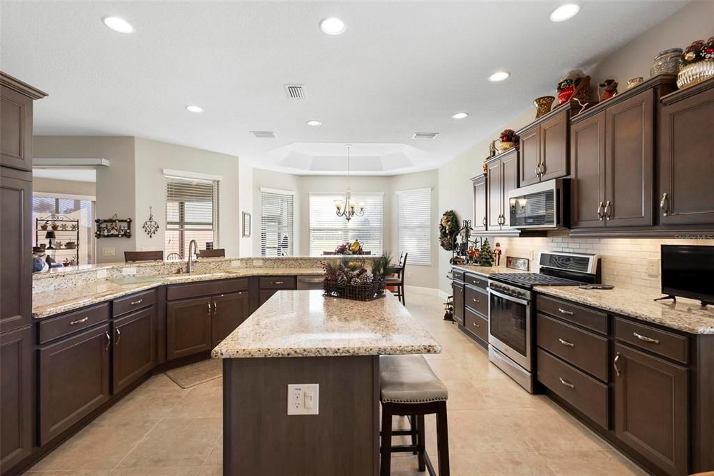 Kitchen with gas stove, farm sink and granite counters