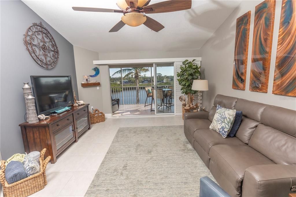 Living Room With Vaulted Ceiling Looking Out To The Water. Quality Furnishings. Condo Is being Sold Furnished!