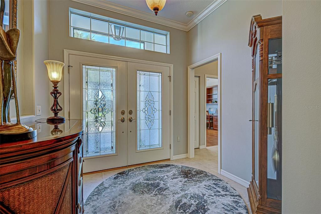 Gracious foyer with transom window and double glass doors, allow the natural light to flow into the home.