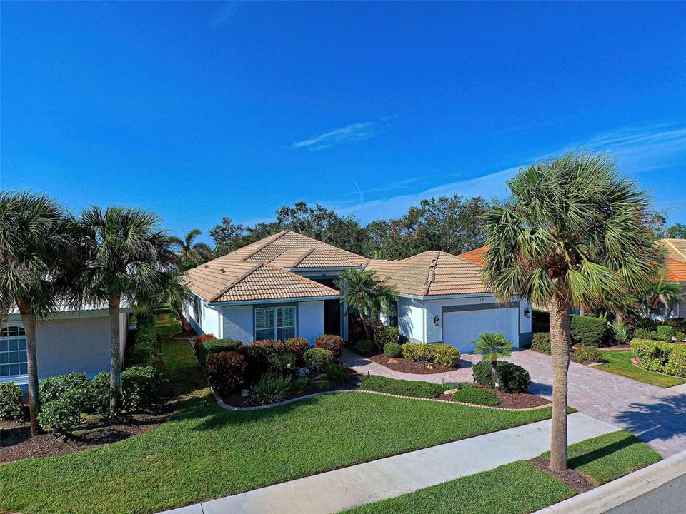 This special home has fabulous curb appeal - paver driveway and walkway, landscape edging and tropical, easy to maintain landscaping.