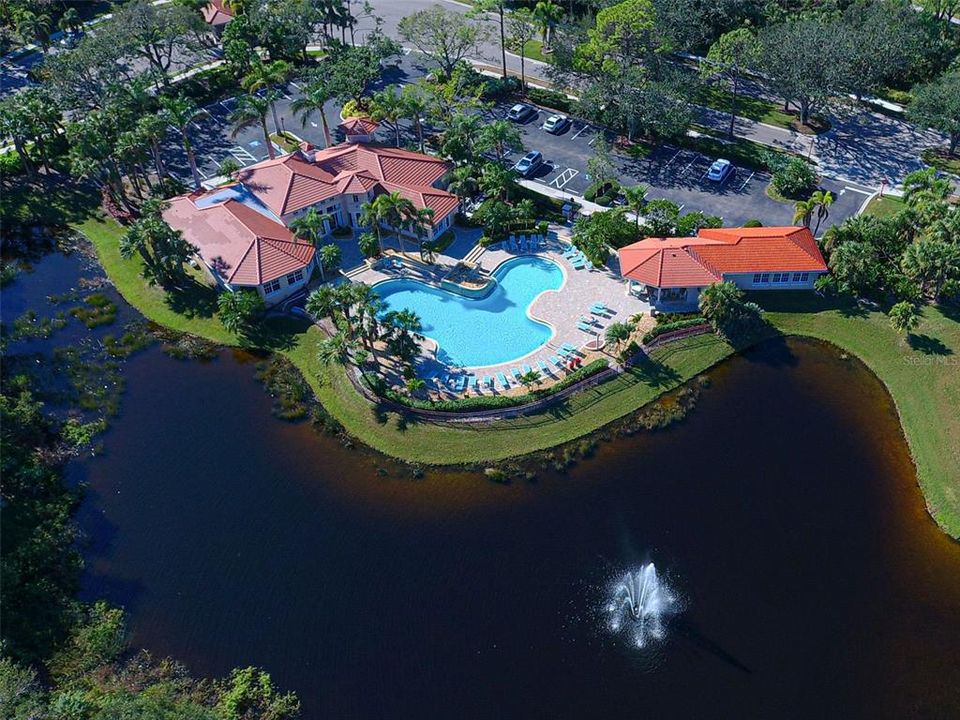 Bird's eye view of clubhouse, pool and fitness center, with lake and fountain views.