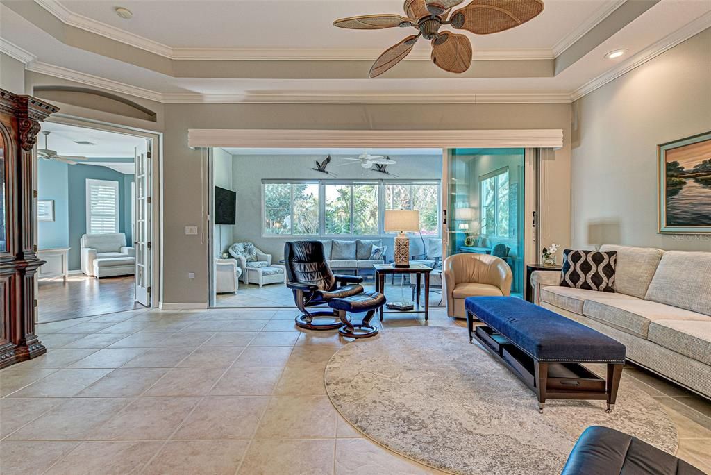 Elegant great room with wall of sliders leading to the Florida room - perfect layout for entertaining.