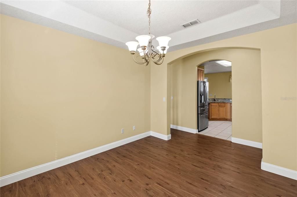 Dining Room with tray ceiling and chandelier