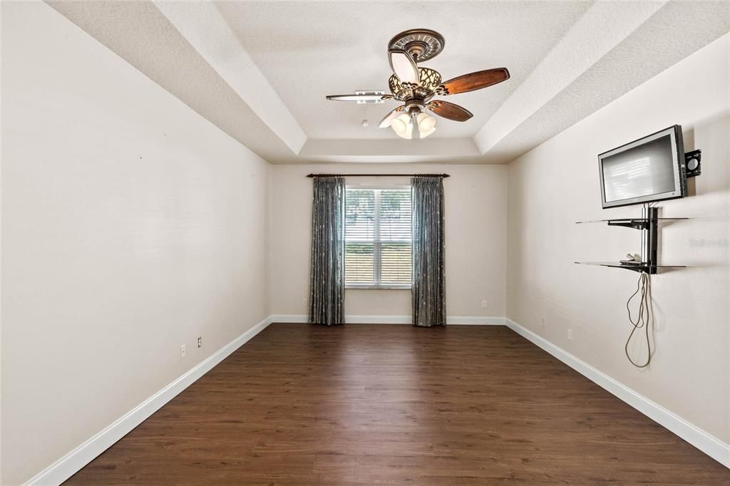 Master Bedroom with tray ceilings and ceiling fan