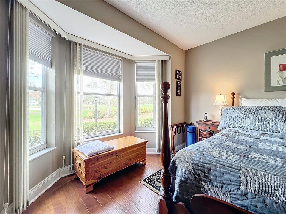 Primary bedroom large bay window invites daylight into the spacious room