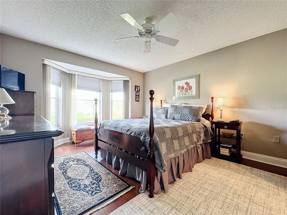 Primary Bedroom is spacious with bay window and golf course view