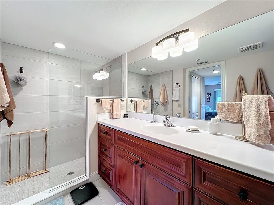 Primary bath includes pocket door between closets and bath