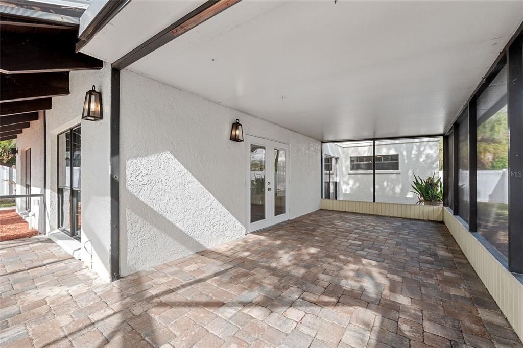 Screen enclosed back patio area for eating outside poolside and no worries about bugs or birds getting to your food.