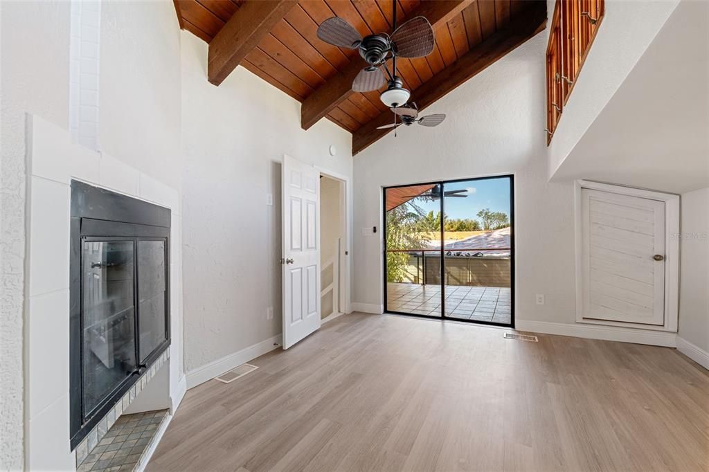 Upstairs master bedroom with a fireplace, very high vaulted ceilings and transient windows for lots of natural light.