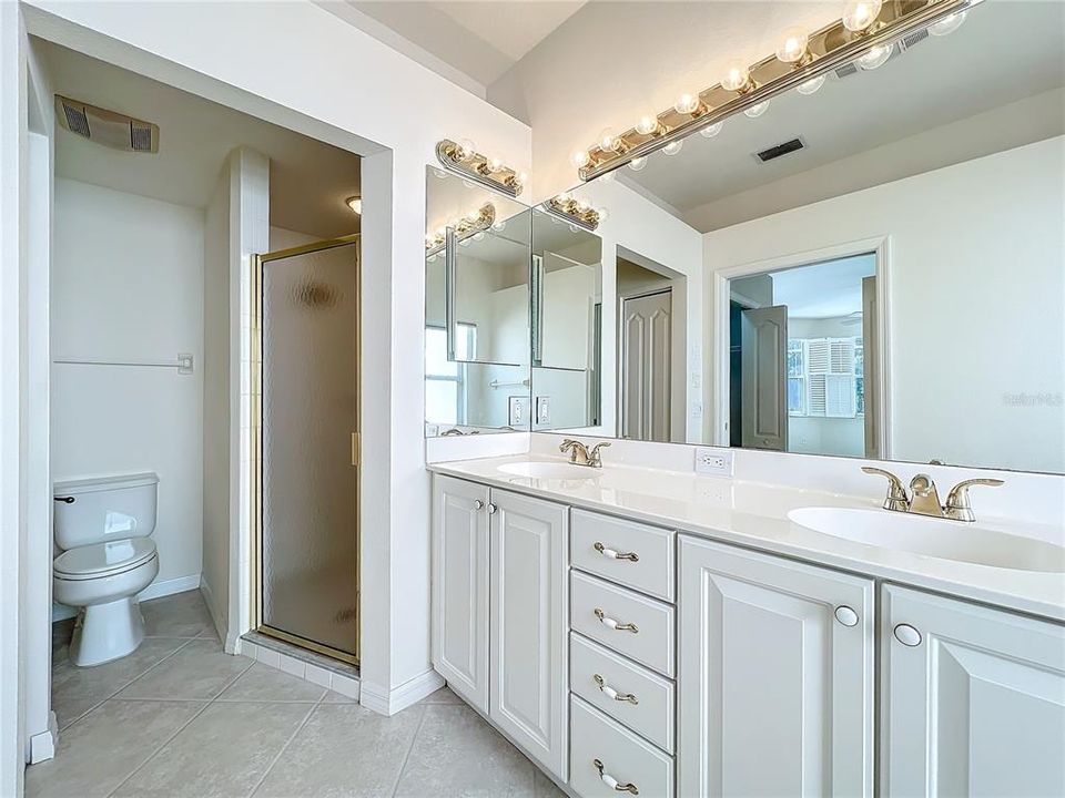 Primary bath twin vanities and shower.