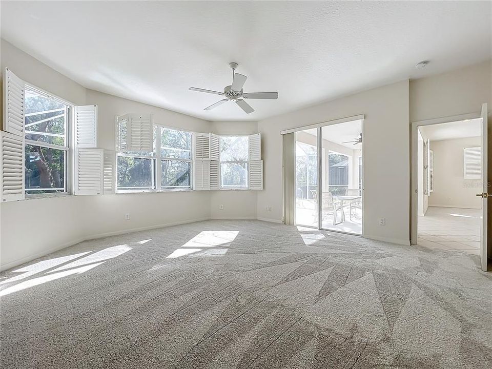 Primary suite with bay windows & Plantation shutters.