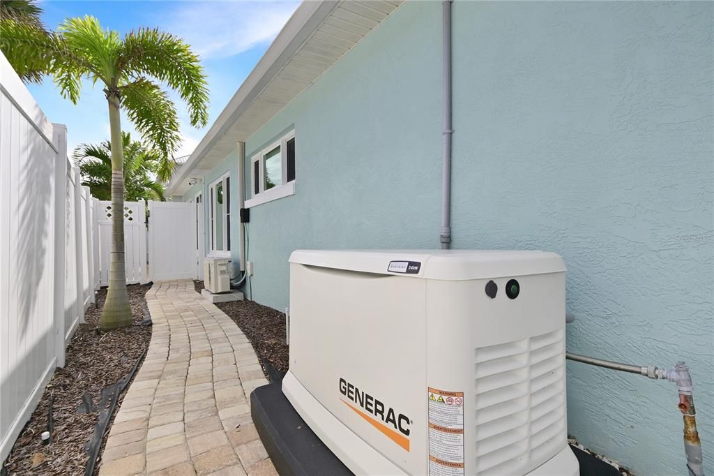 Whole house generator and paver sidewalk wraps around the house.