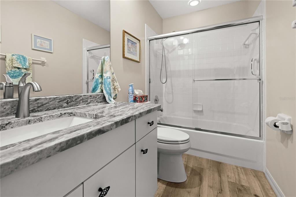 PRIMARY BATHROOM UPDATES INCLUDE GRANITE COUNTERS, UNDER MOUNT SINK,STAINLESS FAUCET AND COMMODE