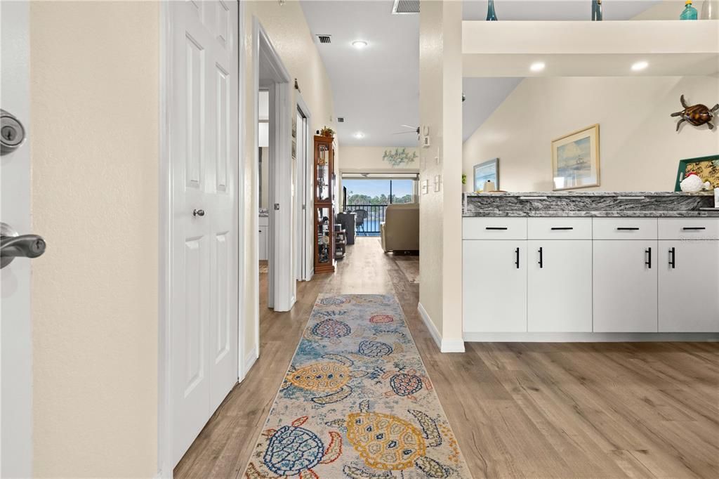 VIEW FROM THE FROM THE FRONT ENTRY THROUGH THE KITCHEN AND LIVING ROOM