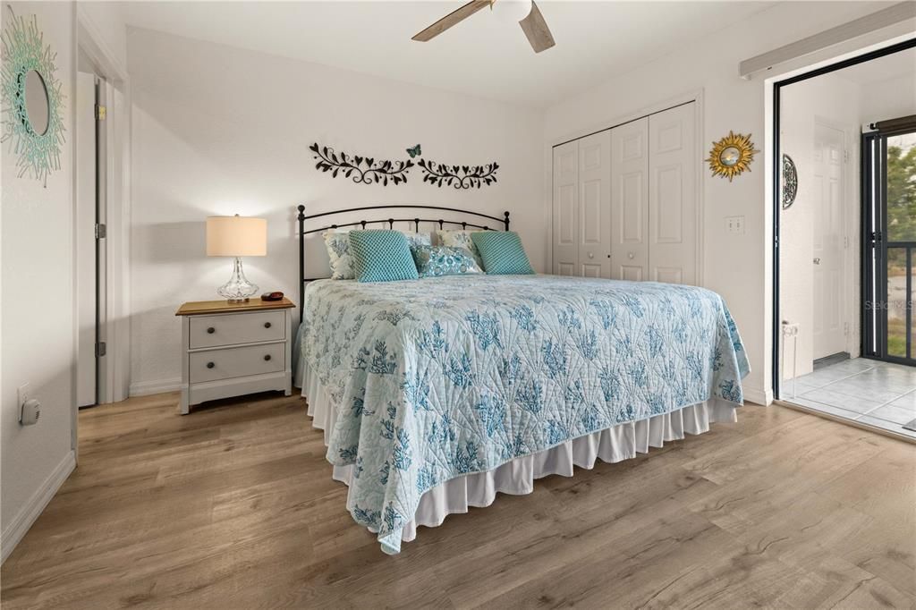 THE PRIMARY BEDROOM HAS SLIDING DOOR TO LANAI, CEILING FAN AND 2 CLOSESTS