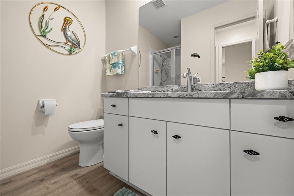 MAIN BATHROOM HAS BEEN UPDATED WITH GRANITE COUNTER, UNDER MOUNT SINK, FAUCET AND COMMODE