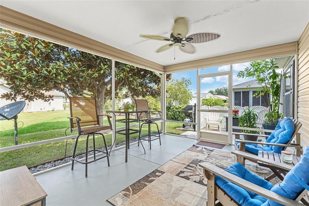 View of SCREEN ENCLOSED LANAI with screen door leading to OPEN PATIO