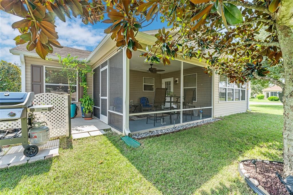 REAR EXTERIOR - OPEN PATIO (L) is adjacent to SCREEN ENCLOSED LANAI (R)