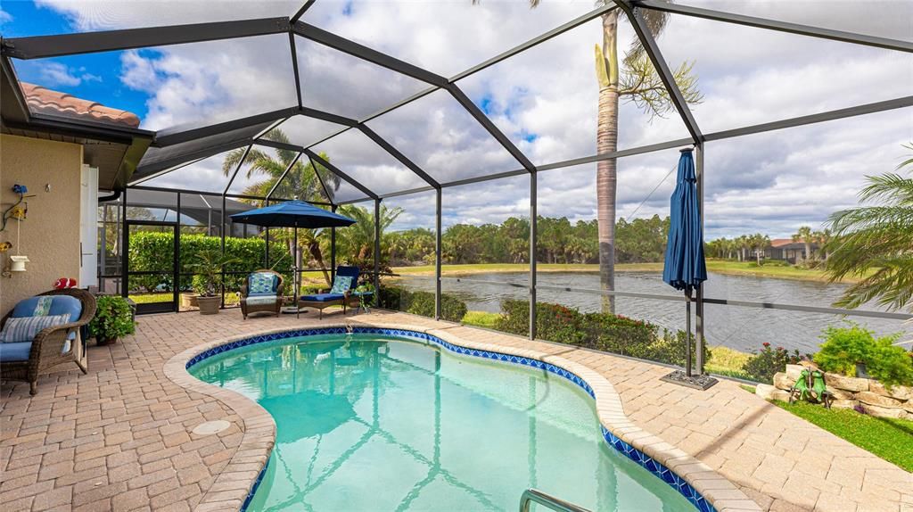 Large Free Form Pool with Lush Landscaping surrounding it.