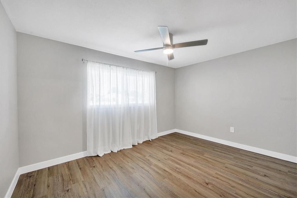 Bedroom 2 with new ceiling fan and impact window