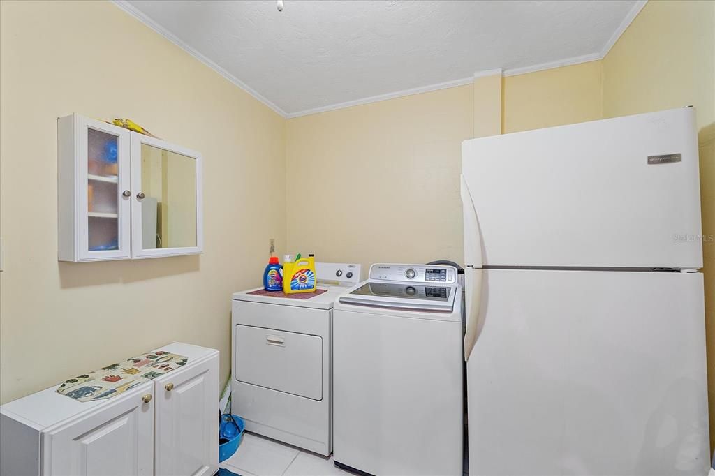 Laundry area is inside behind the kitchen