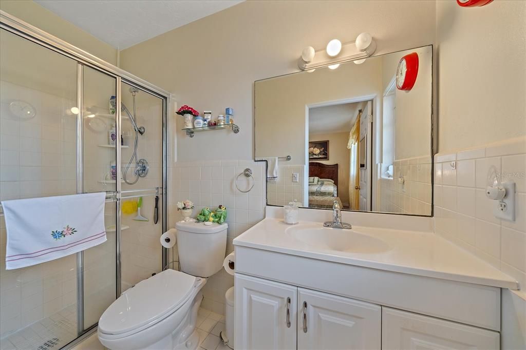 Primary bath looks with well maintained white tile