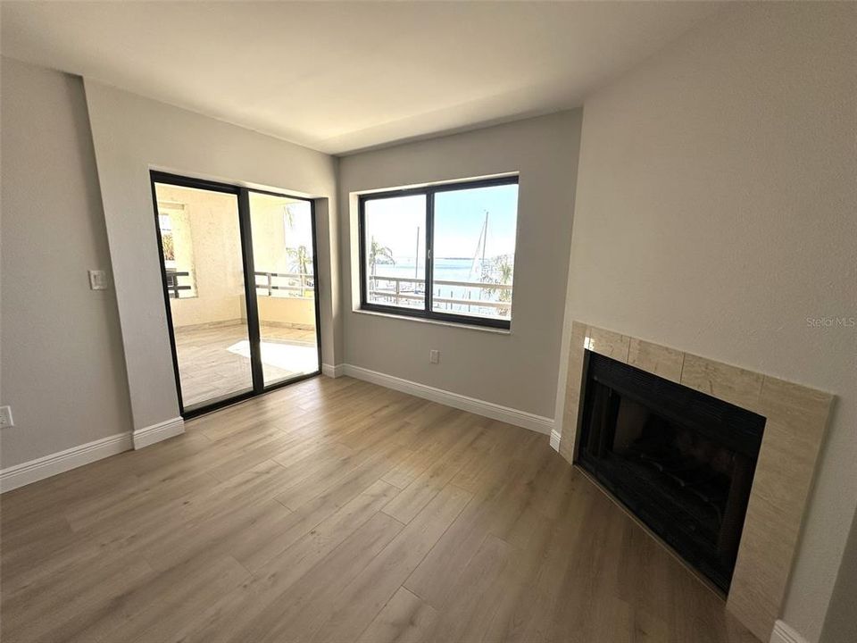 Wood Burning corner fireplace and out to balcony