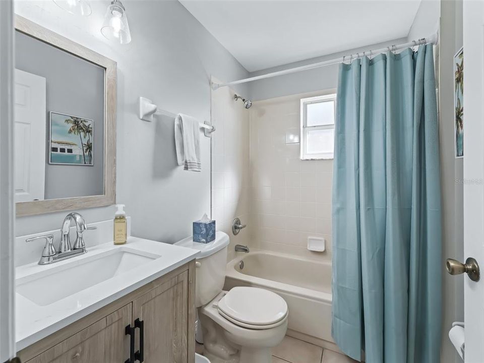 Guest bathroom w/Granite topped vanity & Tiled tub/shower combination