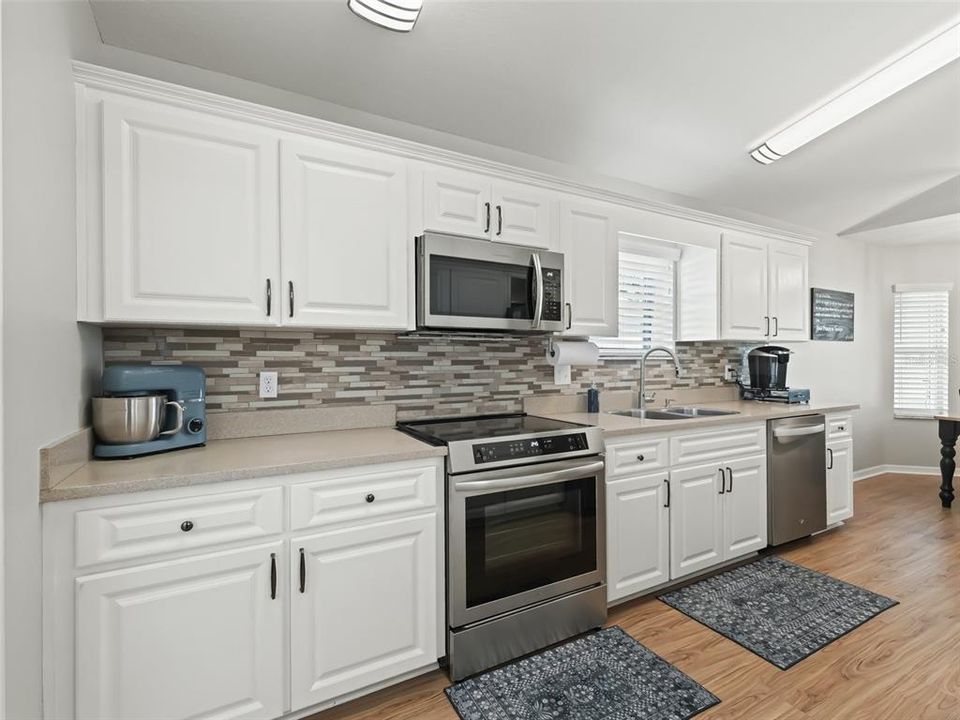 Kitchen w/Tile backsplash & Wood cabinets w/pullouts