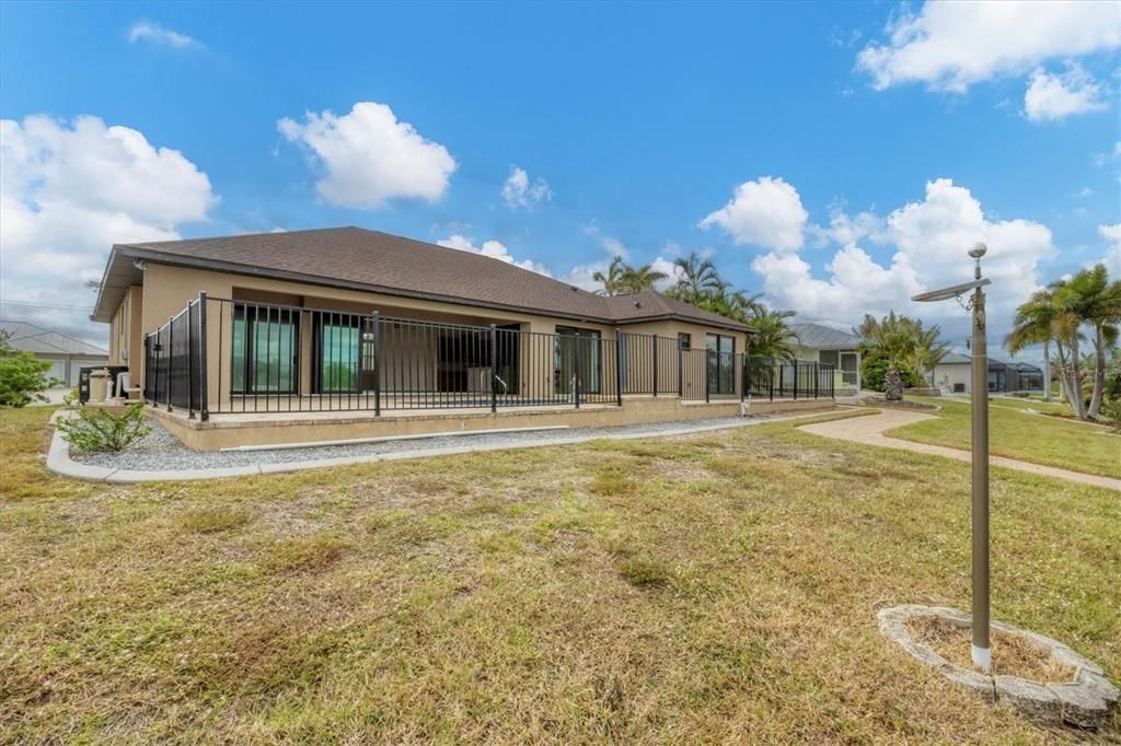 Spacious Backyard with Paver Sidewalk to Dock