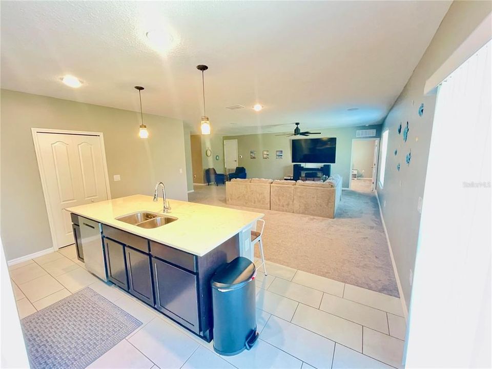 Spacious open kitchen with center island with beautiful solid surface countertops.