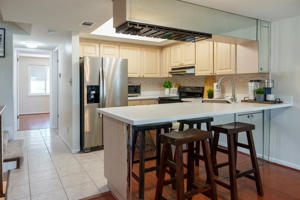 Brand new lighting, quartz counters and work station sink.