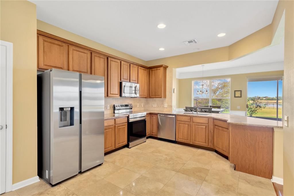 Gourmet Kitchen: The large open kitchen includes a breakfast nook, beautiful granite countertops, lots of cabinet storage, and a breakfast bar. Stainless Steel Refrigerator and Range were installed in Sept 2024. There’s also a convenient pantry for additional storage.