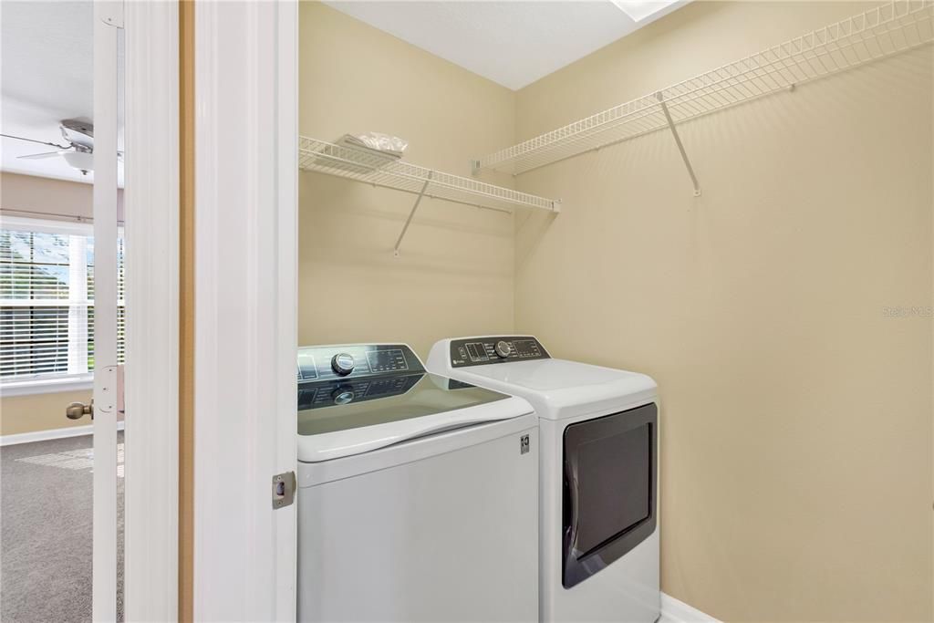 Upstairs Laundry room with GE Profile washer and dryer to convey to buyers.