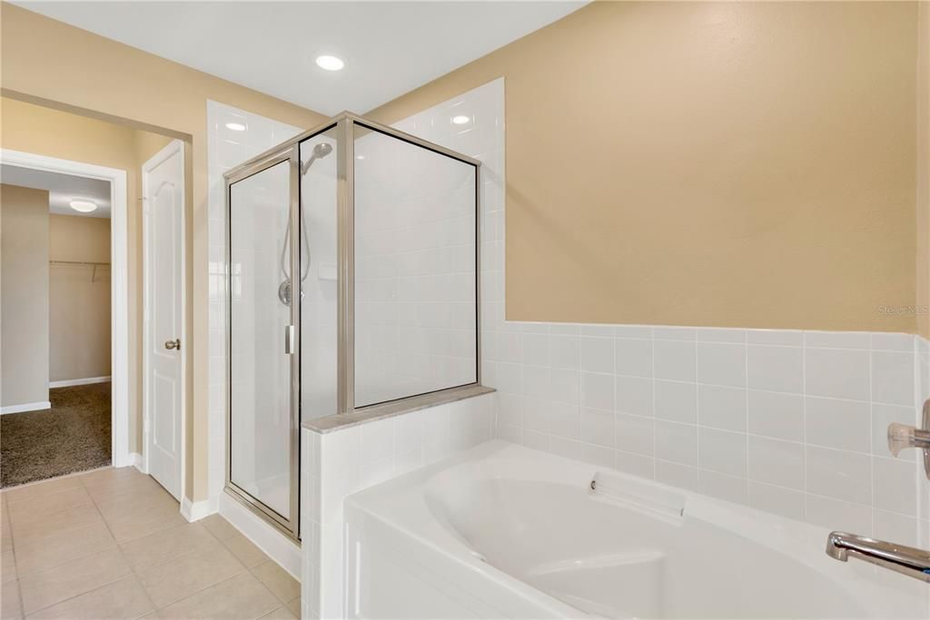 The spacious upstairs primary suite features a huge walk-in closet (13’ x 6’), a luxurious spa-like bath with a large soaking tub and a walk-in shower.