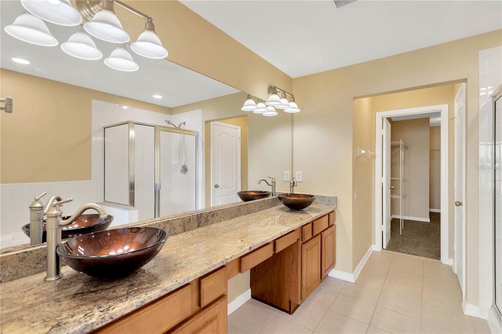 The primary suite features a huge walk-in closet (13’ x 6’), a luxurious spa-like bath with dual vanities, a large soaking tub, and a walk-in shower