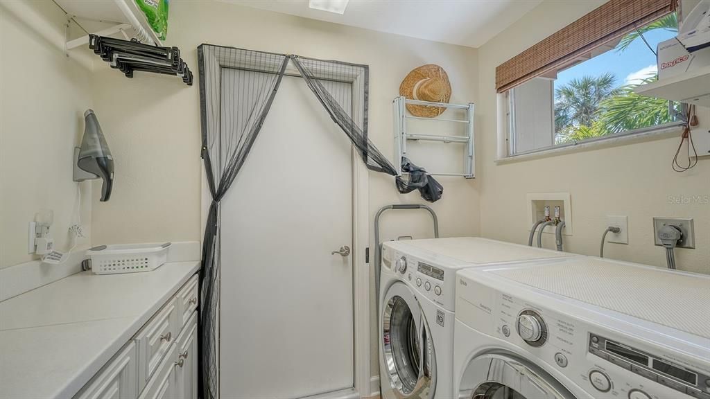 Laundry Room with custom cabinets & a  Front Loading Washer & Dryer