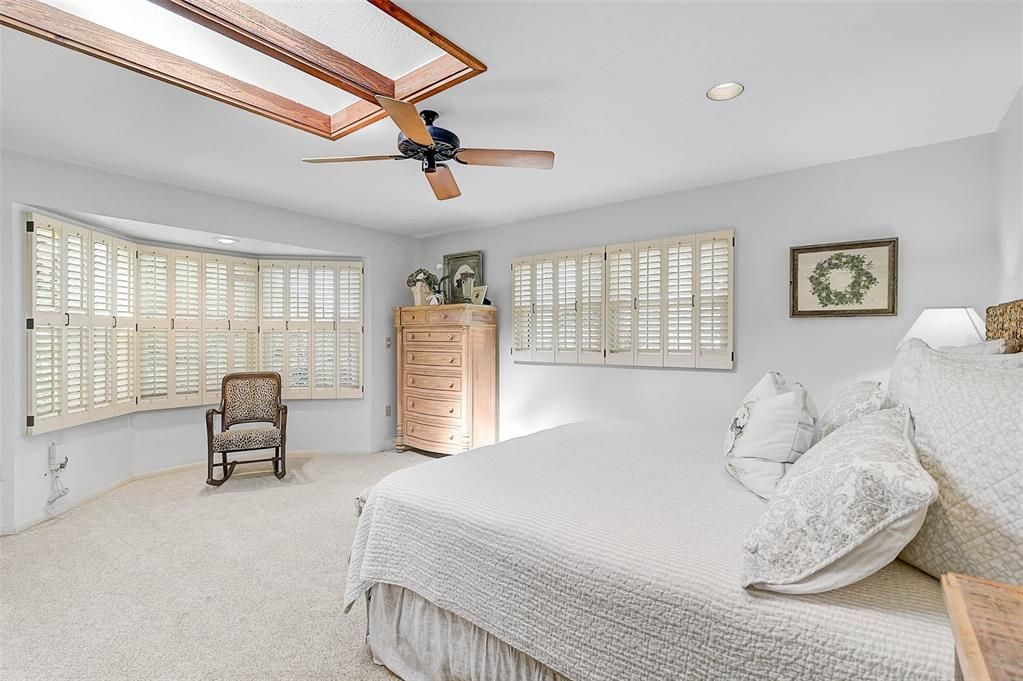 Ensuite Bedroom 4, with a bay window behind the chair.