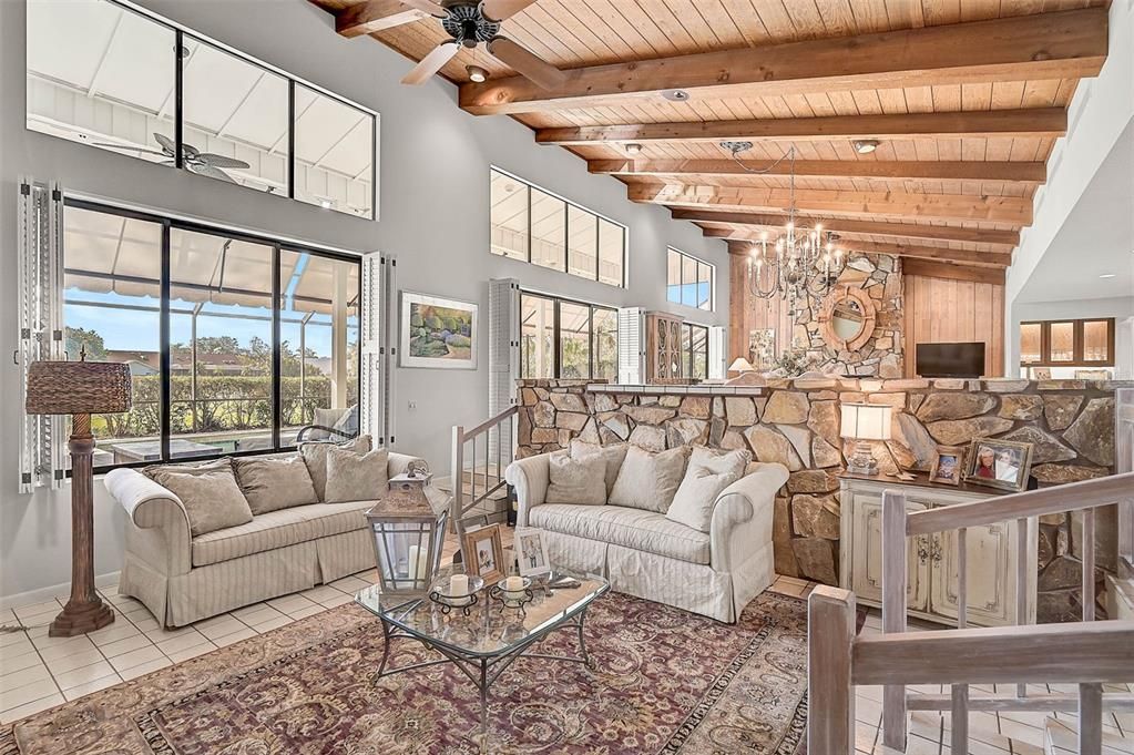 Living Room, with large sliding windows, looking out to the pool area!