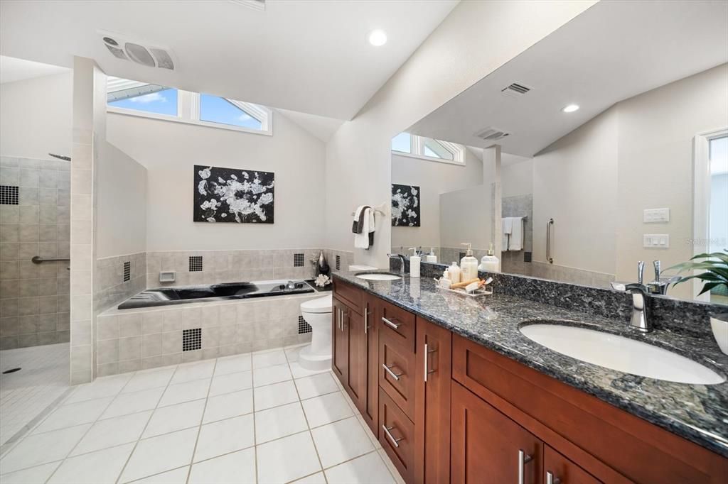 Primary bath area with large soaking tub and separate walk in shower