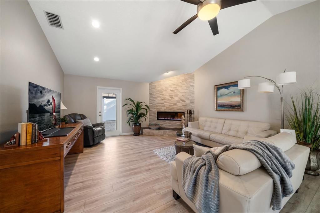 Family room with high ceilings and attractive fireplace.