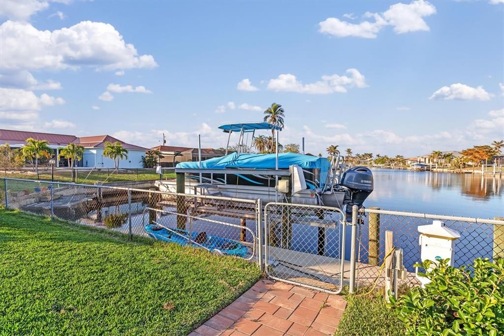 New paved walkway to new 30-ft concrete dock (with water and electric) and 13,000-lb boatlift