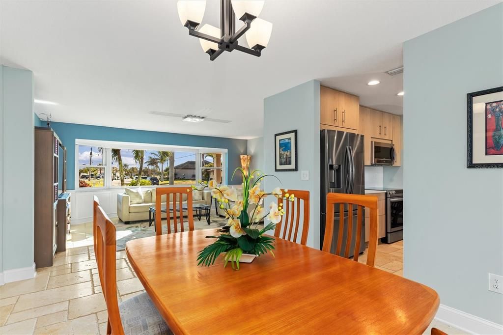 Dining Room with Living Room in background and Kitchen on right side