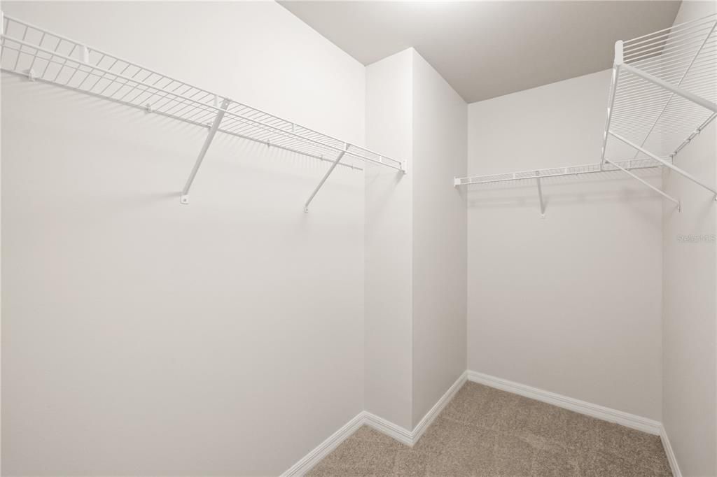 Primary bedroom walk in closet.