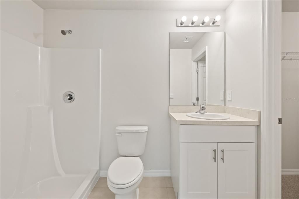 Primary bedroom bathroom with standup shower.