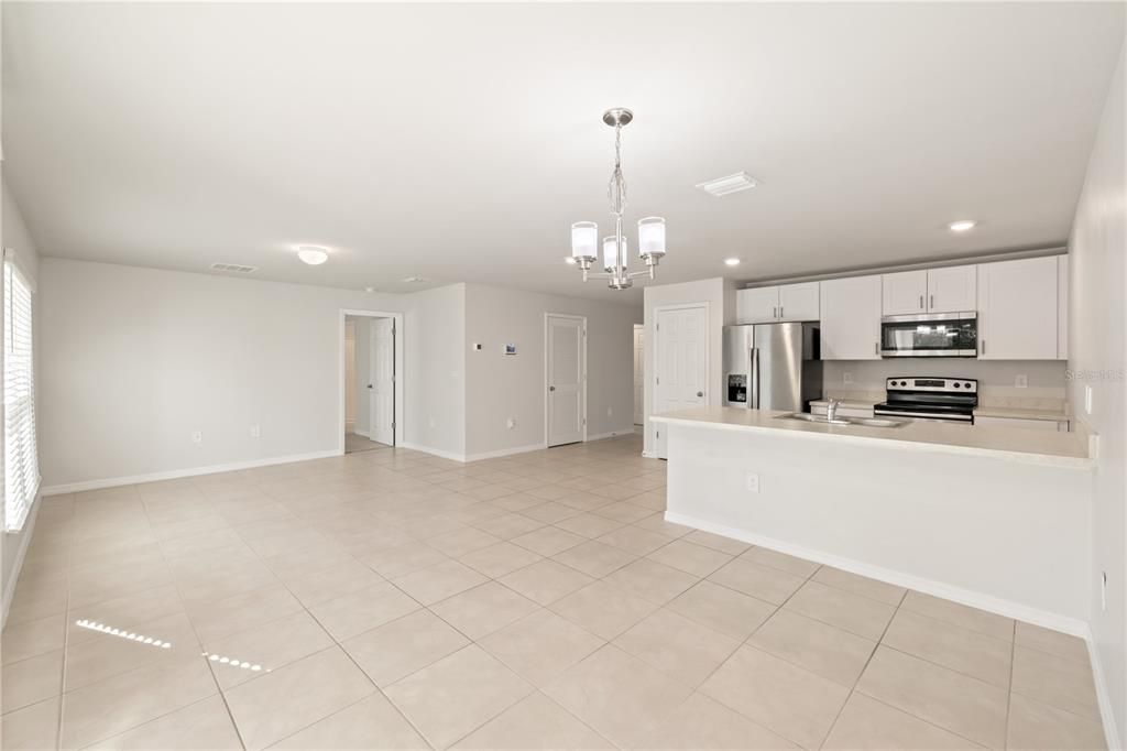 Open floor plan showcasing the living room, dining area and kitchen.