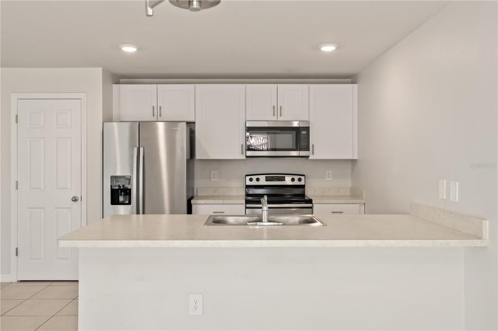 Spacious kitchen featuring stainless steel appliance.