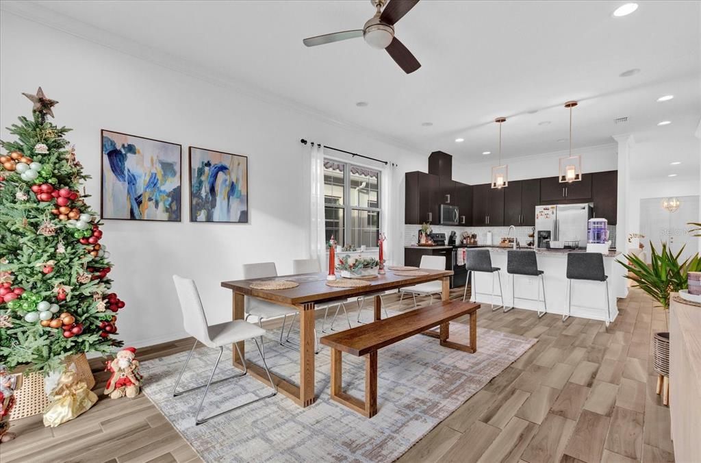 This charming dining room is filled with natural light, featuring large windows with a view of the backyard making it perfect for intimate meals or family gatherings.