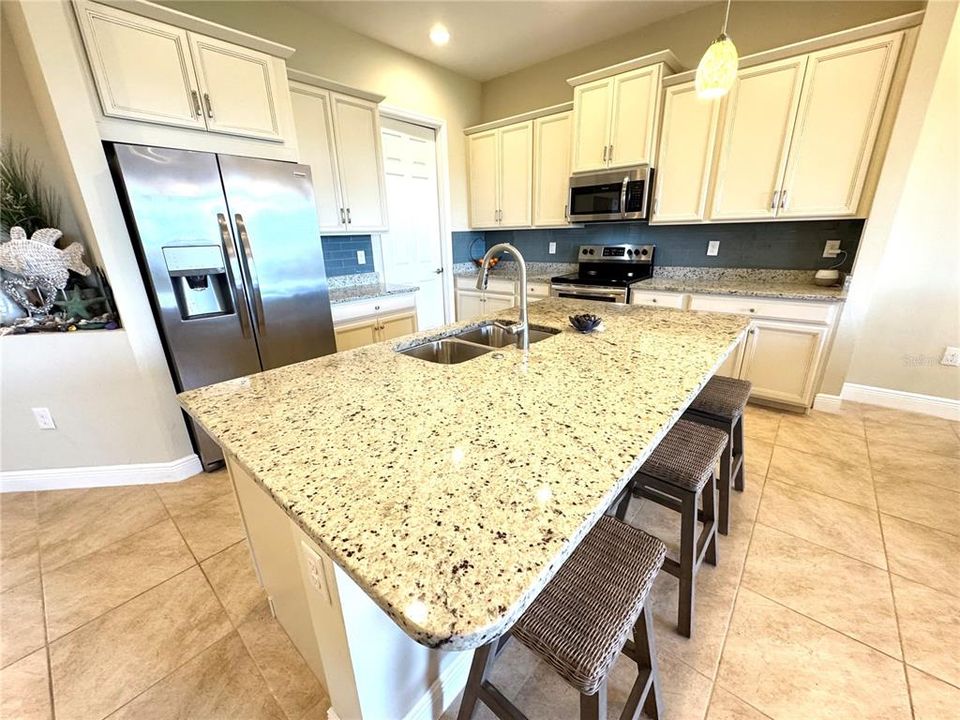 Breakfast bar with pendant lighting and granite countertops